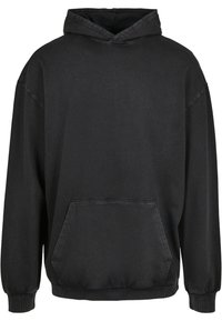 Hoodie noir surdimensionné avec poche kangourou à l'avant et poignets côtelés, présenté sur un fond blanc.