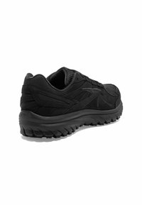 Zwarte sportieve schoen met een gestructureerde bovenkant, een gevoerde zool en een opvallend profielpatroon geschikt voor verschillende terreinen.