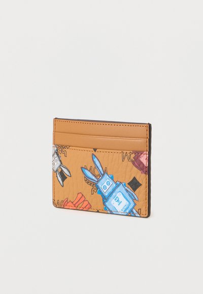 Κάρτα θήκης από υλικό με υφή σε αποχρώσεις του καφέ, με πολύχρωμα καρτούν σχέδια λαγού. Διαθέτει πολλαπλές θήκες για κάρτες. Οι άκρες είναι ραμμένες.