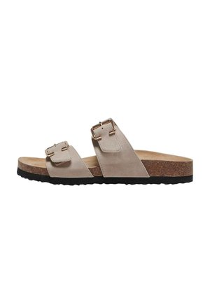 Sandalia tipo pala de ante beige con dos hebillas doradas ajustables, plantilla de corcho y suela de goma negra texturizada.