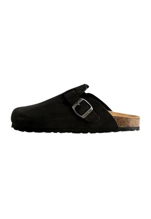 Black suede clog with an adjustable metal buckle, cork footbed, textured sole, and a rounded toe design for comfort and support.