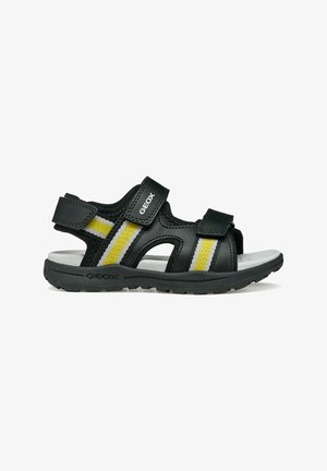 Sandalo Geox nero e giallo con cinturini regolabili in Velcro e suola imbottita progettata per comfort e aderenza.