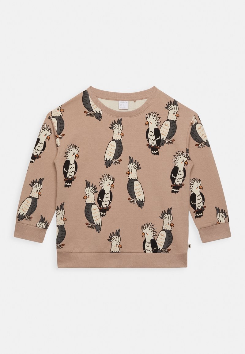 Chemise à manches longues marron clair avec motif répété de cacatoès style dessin animé en noir, blanc et orange.