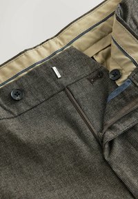Gray patterned trousers with a zipper and button closure, featuring a tan lining and blue accents on the inner waistband.