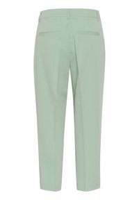 Pantalons vert menthe avec une texture lisse, présentant une coupe droite, une taille ajustable et deux poches arrière.