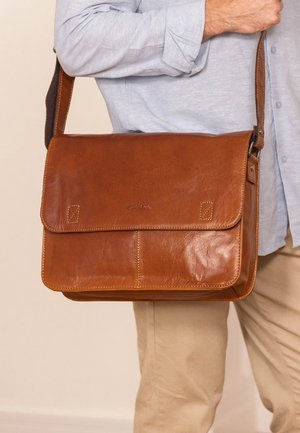Brown leather messenger bag with a flap, featuring a stitched accent and adjustable shoulder strap. Smooth texture and crafted design details.