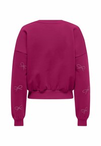 Sweat-shirt à manches longues rose foncé avec poignets et ourlet côtelés, avec de petits motifs de nœuds à pois sur les deux manches, vu de dos.