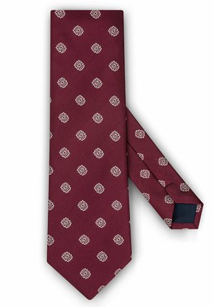Burgundzka muszka z białym kwiatowym wzorem, wykonana z textured tkaniny. Posiada spiczasty koniec i jednolitą, ciemnoniebieską podszewkę.