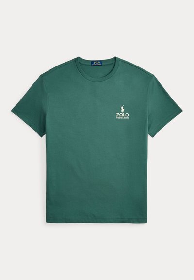 Green cotton t-shirt with short sleeves and a crew neck. Features a small white logo on the left chest. Smooth texture, casual design.