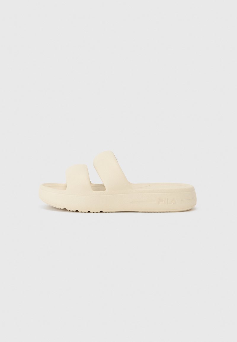 Beige FILA slide sandal with two wide straps and a thick sole, designed for casual wear.