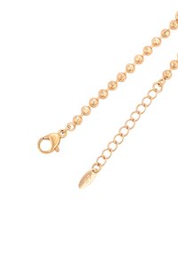 Estensione della collana in tono oro con catena a pallini rotondi da un lato e catena a maglie piccole con chiusura e etichetta ovale dall'altro.