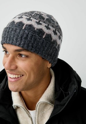 Gray knitted beanie with a floral pattern in pink and white. Ribbed band at the base. Worn with a light-colored fleece collar.