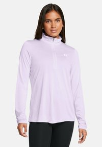 Light purple long-sleeve top with a half-zip neckline and a small white logo on the chest. Soft, smooth fabric.