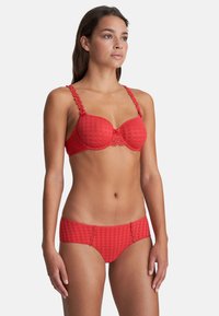 Red bra and panty set featuring a checkered pattern, floral accents on straps and waistband, and a smooth finish.