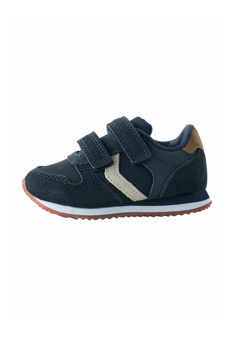 Navy blue children’s sneaker with two Velcro straps, beige side detail, brown heel patch, white midsole, and brown rubber sole.