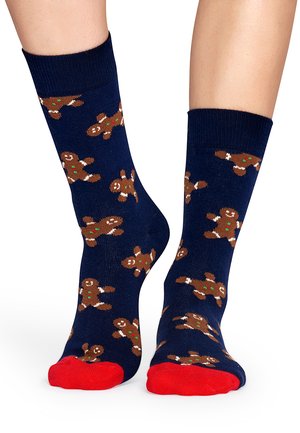 Marineblau Socken mit Lebkuchenmann-Muster, featuring braune Figuren mit grünen Knöpfen. Rote Akzente an den Zehen und gerippten Bündchen. Mischgewebe aus Baumwolle.
