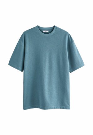 Rövid ujjú, kerek nyakú póló puha, textúrált kék anyagból. Lazán illeszkedő fazon egyenes szegéllyel, látható logók vagy minták nélkül.