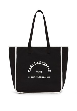Zwarte draagtas met witte bies, lange handvatten en witte tekst aan de voorkant met de woorden "KARL LAGERFELD PARIS 21 RUE ST-GUILLAUME".