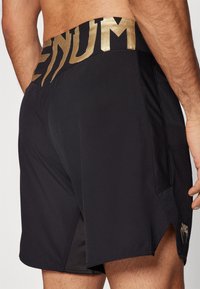Venum RAPID FIGHTSHORTS - Sports shorts - black/gold