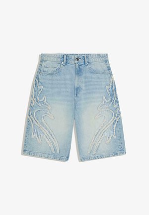 Light blue denim shorts with frayed dragon designs on both legs, front button, zipper, and five-pocket style.