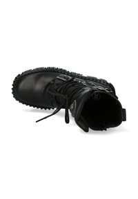 Black leather ankle boots with a rounded toe, textured rubber sole, lace-up front, and metal buckle accents. Interior is lined and textured.