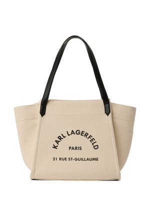 Bézs vászontáska fekete fogantyúkkal, elöl fekete betűkkel nyomtatva a "KARL LAGERFELD PARIS 21 RUE ST-GUILLAUME" felirat.