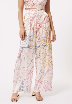 Pantalons amples et fluides en tissu léger, présentant des contours floraux multicolores en rose, bleu et jaune sur un fond crème.