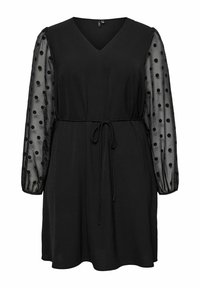 Zwarte jurk met een V-hals en elastische tailleband. Doorzichtige lange mouwen met stippen; zachte stof; lengte boven de knie.