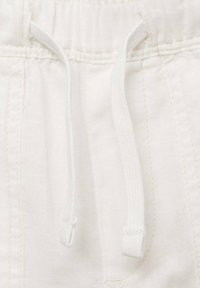 White fabric waistband with a drawstring, featuring a smooth texture and subtle stitching details. The drawstring has round, finished ends.