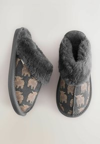 Gray plush slippers with a fold-over cuff feature brown bear patterns and a textured surface. Rubber sole for durability.
