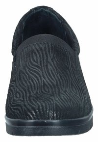 Black slip-on shoe with a textured surface featuring wavy patterns, elastic band at the top, and a flat rubber sole.