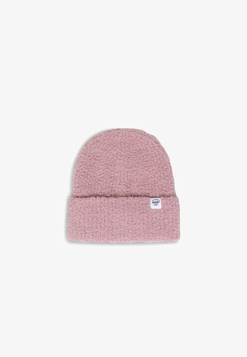 Light pink beanie hat made of textured, fuzzy material with a folded cuff. Features a small brand label on the side.