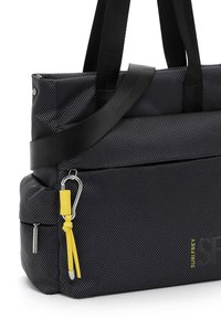 Black textured tote bag with black handles. Features a yellow accent strap and metal hardware. Includes a zippered pocket and carabiner detail.