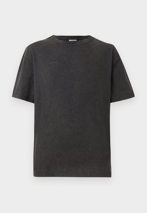 Black oversized t-shirt made of soft fabric, featuring short sleeves, a round neckline, and minimalistic embossed logo details on the front.