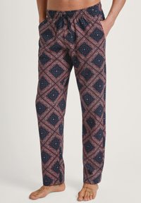 Navy en kastanjebruine gestipte pyjamabroek met een elastische tailleband, trekkoord en twee zijzakken met een geometrisch ontwerp.