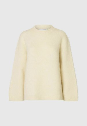 Hellbeige, übergroßer Pullover aus weichem, flauschigem Material. Mit Rundhalsausschnitt und überschnittenen Schultern, sowie gerippten Bündchen und Saum.