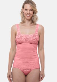 Pink tank top and matching underwear set with floral lace trim, soft fabric, fitted design, and flat seams for comfort.