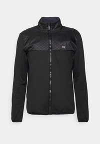 Czarna kurtka zapinana na zamek błyskawiczny, z pikowaną górną częścią klatki piersiowej, stójką, długimi rękawami i małym białym logo "CK" na lewej piersi.