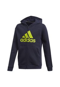 Felpa con zip di colore blu navy realizzata in tessuto morbido, con un grande logo Adidas riflettente giallo e due tasche frontali. Polsini e orlo texturizzati.