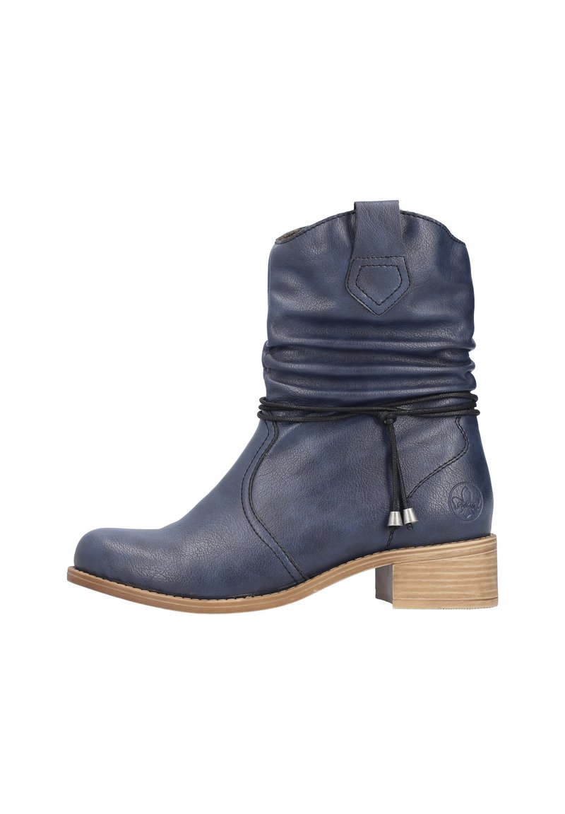 Bottine en cuir bleu avec tige froncée, coutures latérales et petits lacets décoratifs. Talon en bois avec surface texturée, hauteur de 5 cm.