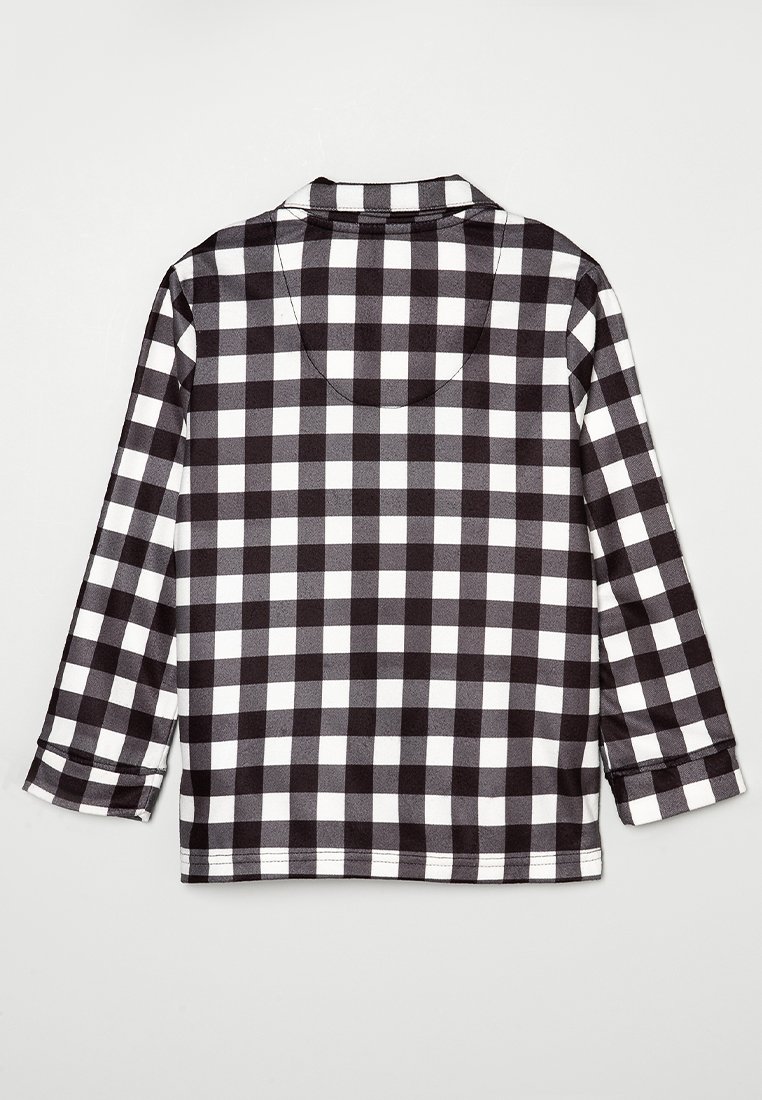Chemise à carreaux noire et blanche, dotée d'un col, de manches longues et d'un ourlet droit. Le tissu semble lisse avec une texture douce.