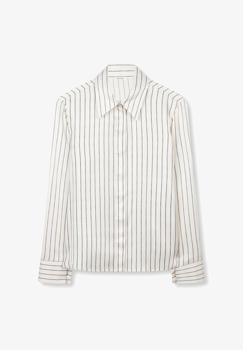 Blouse blanche à manches longues avec rayures verticales noires, col pointu et poignets boutonnés, présentée à plat sur un fond blanc.