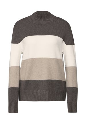 Neulepusero ruskeassa, beige- ja kermavärisissä raidoissa. Omistaa korkean kaulan ja ribatut hihansuut, löysästi istuva. Pehmeä rakenne.