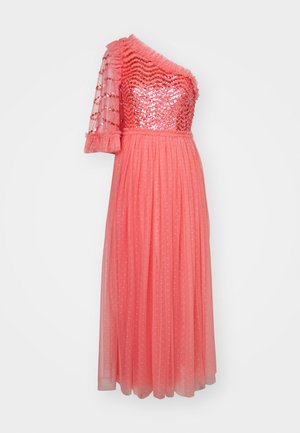 Coral evening dress with one sequined shoulder, ruffled neckline, and a flowing skirt featuring polka dots. Sheer fabric and textured details.