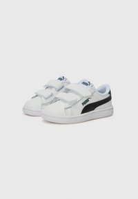 White sneakers with two Velcro straps, black accent on the side, and a textured surface. Features Puma branding on the tongue and side.