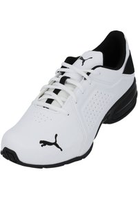 White athletic shoe with black accents, lace-up design, perforated sides, and a prominent black Puma logo on the outer side. Textured rubber sole.
