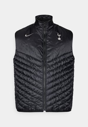 Gilet nero imbottito realizzato in materiale lucido, con colletto alto e motivo trapuntato diagonale. Logo ricamato sul petto e zip totale.
