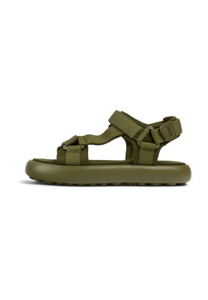 Green rubber sandals with adjustable fabric straps, a flat sole, and textured bottom for grip. Features a minimalistic design.
