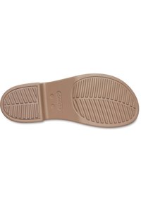 Semelle de chaussure en caoutchouc de couleur brun clair, contournée avec des rainures pour une meilleure traction, dotée de trous de drainage circulaires et d'un logo en relief près du talon.