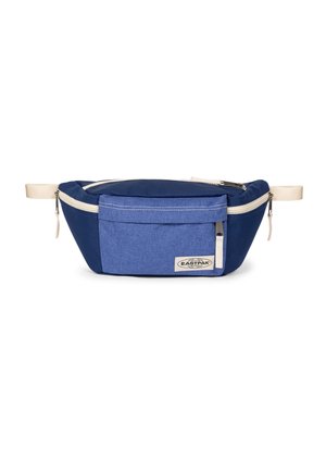 Riñonera Eastpak azul con bolsillo frontal, tiradores de cremallera beige y correas beige ajustables sobre fondo blanco.